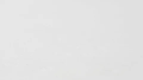 Isolated black olives roll on the table on a white background Stock Footage 92292296