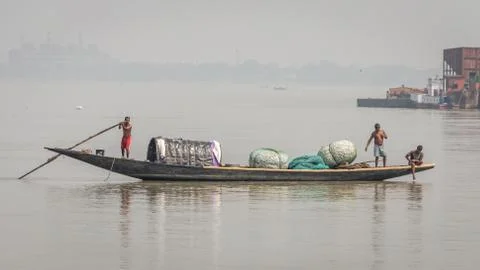 An isolated boat on river Hooghly with poor fishermen Stock Photos
