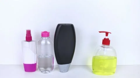 Isolated bottles of detergents on a white background. The hand takes the jars of Stock Footage 146598599