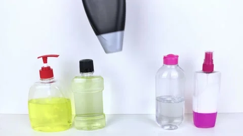 Isolated bottles of detergents on a white background. The hand takes the jars of Stock-Footage 146598632