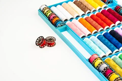 Isolated box with bobbins of threads on a white background Stock Photos