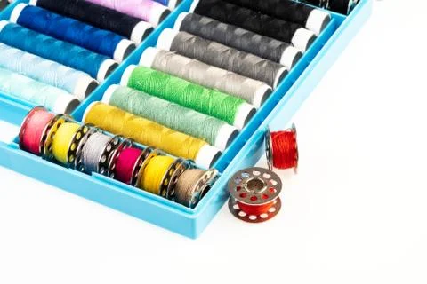 Isolated box with bobbins of threads on a white background Stock Photos