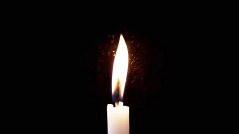 Isolated Burning Candle with Bright Flame on Dark Background with Falling Snow Stock Footage 312013217