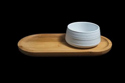 Isolated Ceramic mug of tea, made of white clay, on black background. Stock Photos