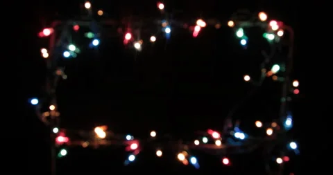 Isolated Christmas lights string, frame along the contour on a black background. Stock Footage 146726125