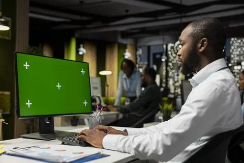 Isolated chroma key on desktop pc with black analyst analyzing KPI metrics Stock Photos