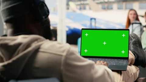 Isolated chroma key laptop with black man combining vacation and freelance work Stock Footage 333173530