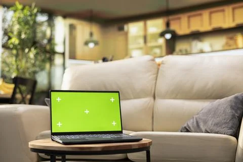Isolated chroma key screen in cozy bright interior with coffee table Stock Photos