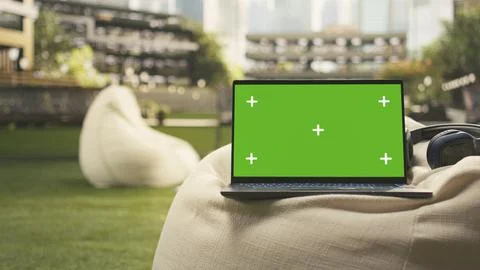 Isolated chroma key screen on laptop placed in outdoor campus Stock Photos