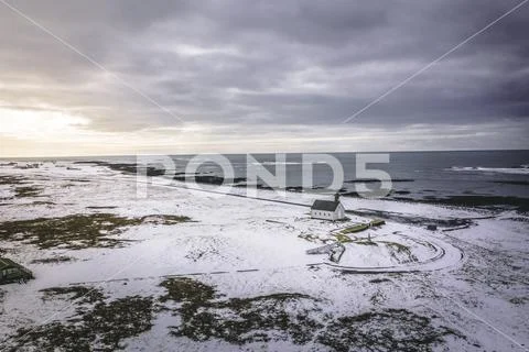 An Isolated Church in Snowy Conditions Next to the Sea Stock Photos