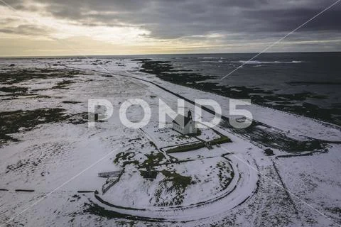 An Isolated Church in Snowy Conditions Next to the Sea Stock Photos