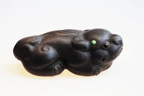 Isolated clay dragon figurine for the eastern tea ceremony on a white backgro Stock Photos