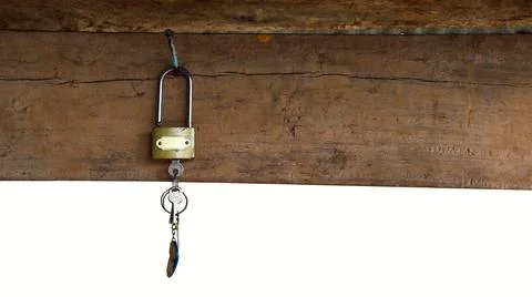 Isolated with clipping paths a key plugged in the keypad hanging on wooden bar Stock Photos