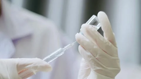 Isolated close up doctor's doing preparation of an injection medicine a Stock-Footage 336586892