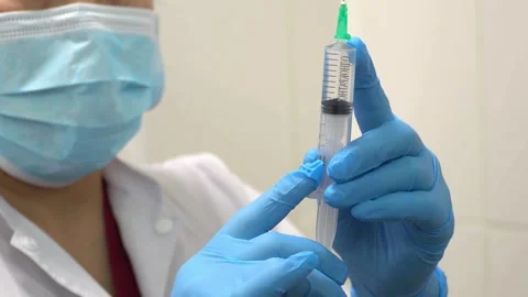 Isolated close up doctor's doing preparation of an injection medicine a Stock-Footage 336586979