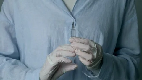 Isolated close up doctor's doing preparation of an injection medicine a Stock-Footage 336587024