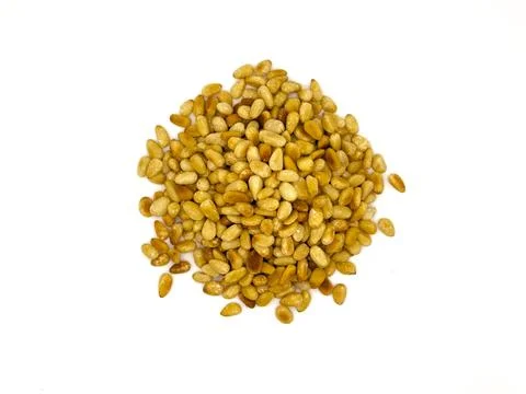 Isolated close up of lightly toasted pine nuts in a pile Stock Photos