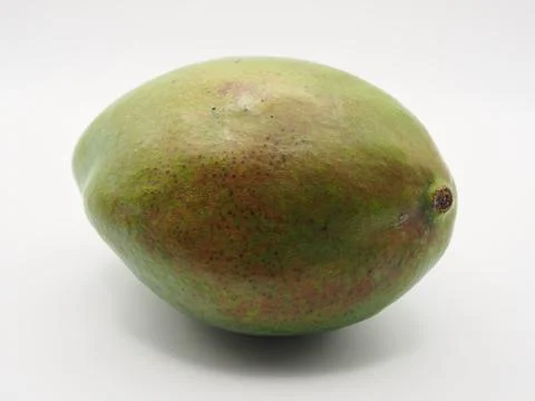 Isolated close-up of a mango fruit seen from the side on white background. .. Stock Photos