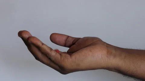 Isolated close shot of a black man's hand with tablets falling on his palm Stock Footage 147095871