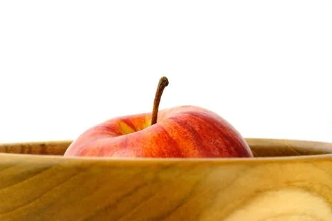 Isolated - close up single red Apple above wooden bowl / basket Stock Photos