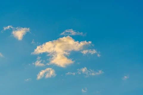 Isolated Cloud Illuminated by Sunset Light 스톡 사진