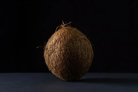 Isolated coconut on a black background. Stock Photos