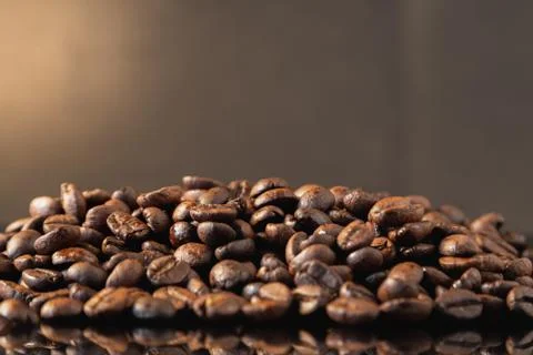 Isolated coffee beans reflected on surface for luxury sensation. Stock Photos