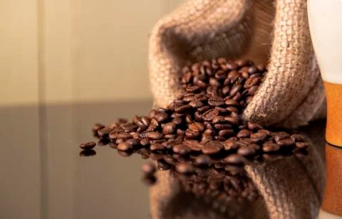 Isolated coffee beans reflected on surface for luxury sensation. Stock Photos