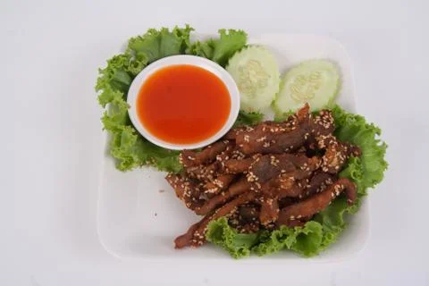 Isolated deep fried beef slice with herbs with delicious taste on white backg Stock Photos