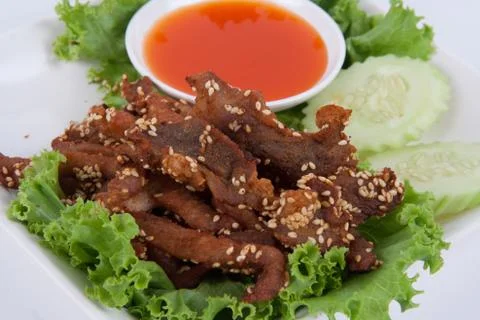 Isolated deep fried beef slice with herbs with delicious taste on white backg Stock Photos