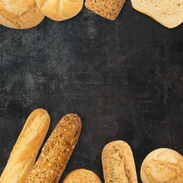 Isolated different kinds of bread on a black background. Photo of variety of  Stock Photos