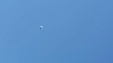 Isolated distant paraglider flying in blue sky. Copy space Stock Footage 144829058