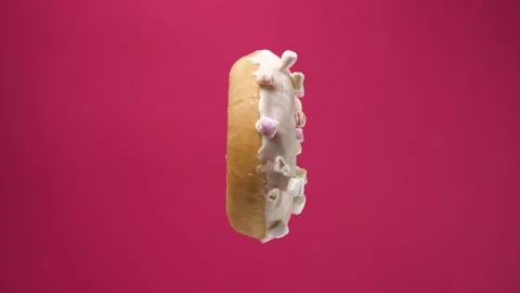 Isolated donut rotates on pink background. A beautiful footage of sweets for Stock Footage 132604114