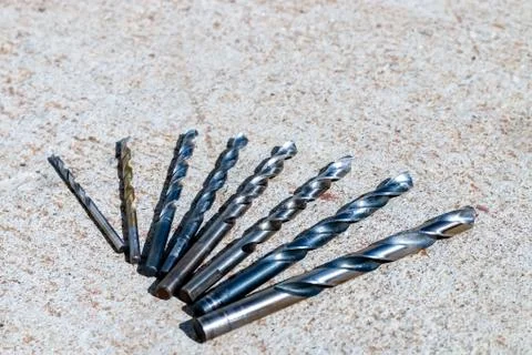 The Isolated Drill Bits with the Gray Ground Background Stock Photos