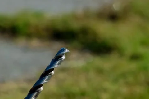 The Isolated Drill Bits with the Green Ground Background Stock Photos