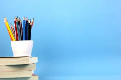 The isolated education elements books, pens, pencils on light blue backgrou.. Stock Photos