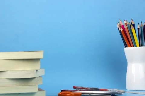 The isolated education elements books, pens, pencils on light blue backgrou.. Stock Photos