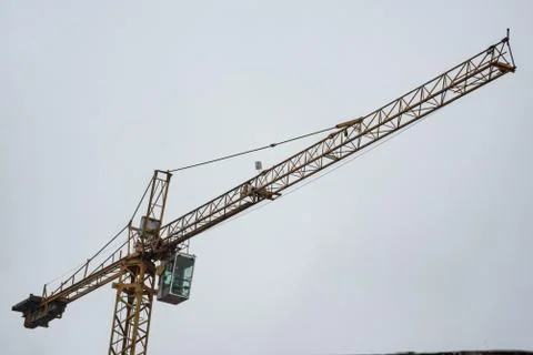 Isolated empty construction crane on a cloudy and rainy day Stock Photos
