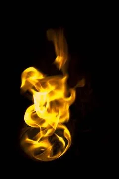 Isolated fire flames on black background, darkness fire with a black backg... Stock Photos