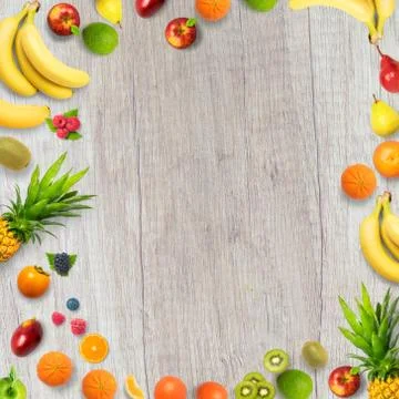 Isolated flat top view of different types of fruits on a wooden background wi Stock Photos