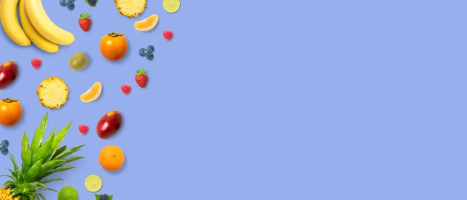 Isolated flat top view of different types of fruits on a light blue backgroun Stock Photos