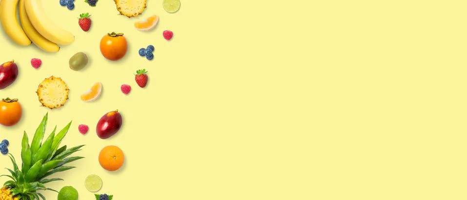 Isolated flat top view of different types of fruits on a soft yellow backgrou Stock Photos