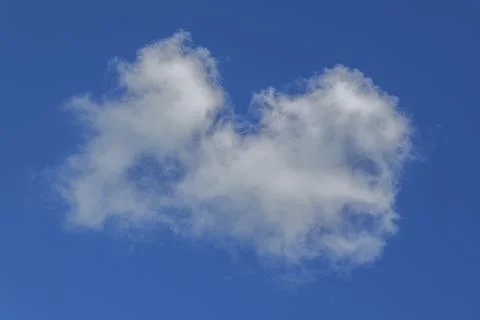Isolated fluffy white cloud in vibrant blue sky with soft edges and minimal Stock Photos