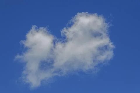Isolated fluffy white cloud in vibrant blue sky with soft edges and minimal Stock Photos