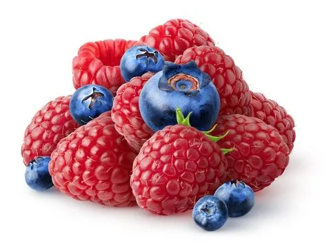 Isolated fresh berries. Pile of raspberry and blueberry fruits isolated on white Stock Photos