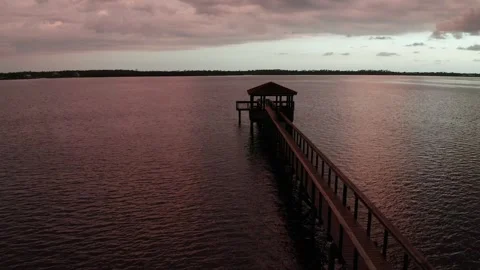 Isolated Gazebo Dock Reaching Over Still Bay at Sunset Stock Footage 341131269