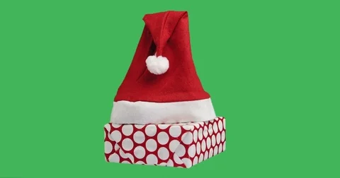 Isolated gift box and Santa hat on green background. Stock Footage 82702381