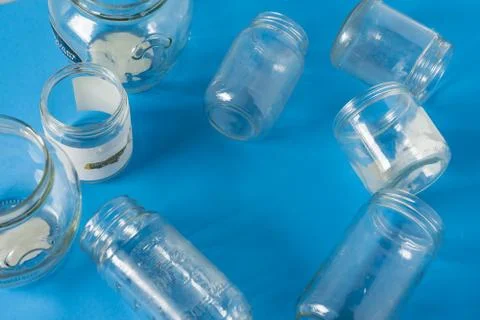 Isolated glass jars without lids flat on blue background with room for copysp Stock Photos