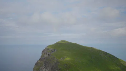 Isolated Grass-Capped Sea Cliff Headland in Nordic Summer Stock Footage 340140240