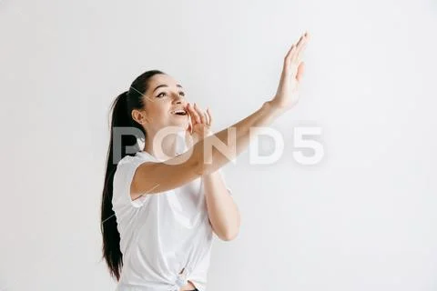 Isolated on gray young casual woman shouting at studio Stock Photos
